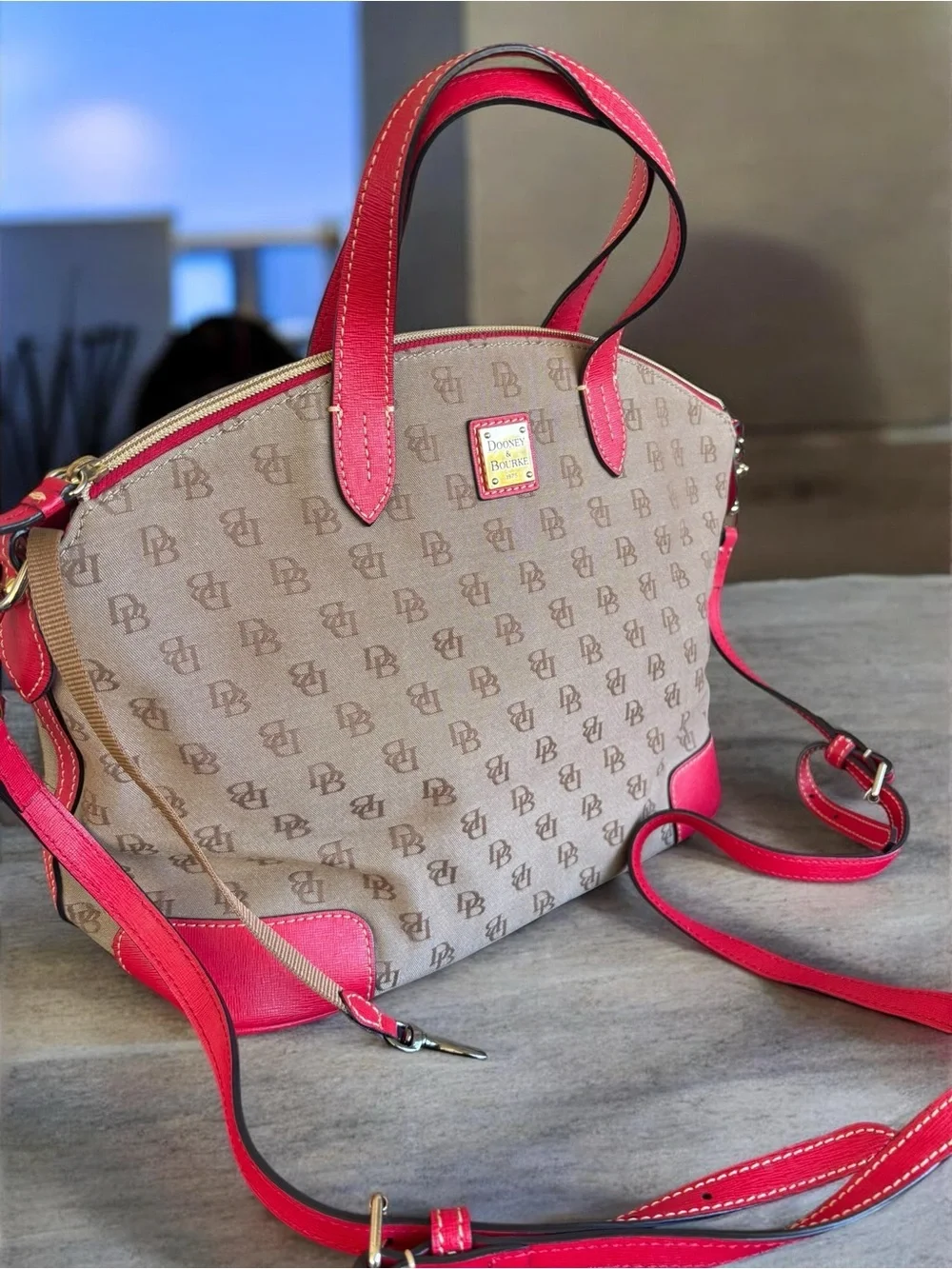 Dooney & Bourke Signature monogram satchel features vibrant pink leather trim